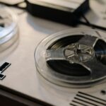 Open-reel tape deck with exposed magnetic tape and reels