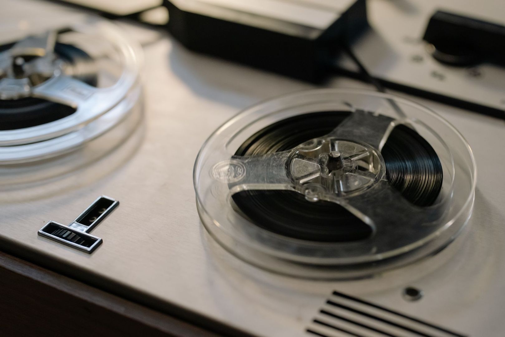 Open-reel tape deck with exposed magnetic tape and reels